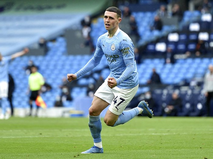 Manchester City's Phil Foden celebrates scoring his side's third goal during the English Premier League soccer match between Manchester City and Everton at the Etihad stadium in Manchester, Sunday, May 23, 2021.(Peter Powel/Pool via AP)