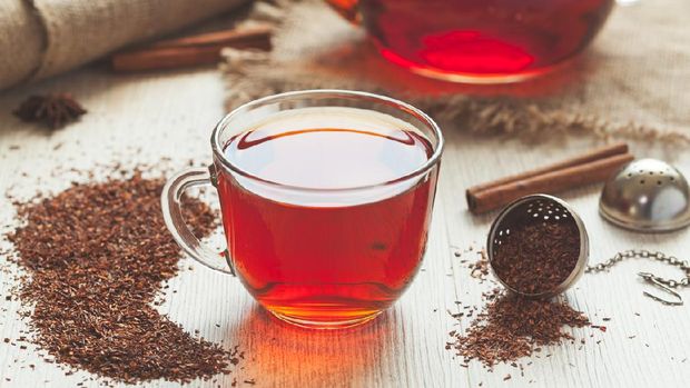 Healthy traditional organic rooibos tea with spices in rustic style with faded instagram filter on vintage wooden table. (iStockphoto/GreenArtPhotography)