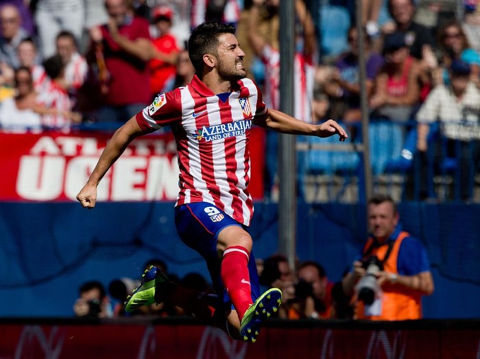 MADRID, SPAIN - SEPTEMBER 14: David Villa of Atletico de Madrid jumps celebrating after scoring their opening goal during the La Liga match between Club Atletico de Madrid and UD Almeria at Vicente Calderon Stadium on September 14, 2013 in Madrid, Spain.  (Photo by Gonzalo Arroyo Moreno/Getty Images)