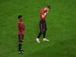 Alex Telles menyeka wajahnya dengan jersey MU. Sedih rasanya kalah lewat adu penalti. (Foto: Getty Images/Aleksandra Szmigiel - Pool)