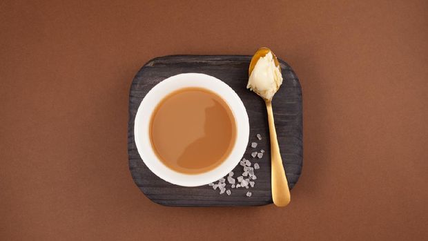 Traditional Tibetan butter tea or churned tea in white bowl. Asian drink known as 