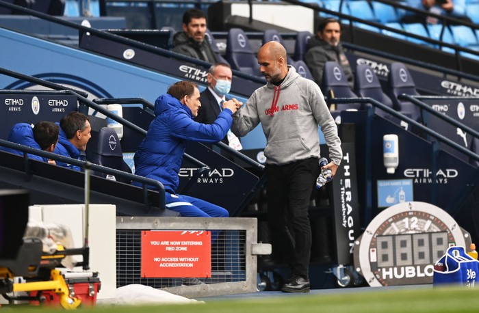 MANCHESTER, ENGLAND - MAY 08: Pep Guardiola (R), Manager of Manchester City greets Thomas Tuchel, Manager of Chelsea prior to the Premier League match between Manchester City and Chelsea at Etihad Stadium on May 08, 2021 in Manchester, England. Sporting stadiums around the UK remain under strict restrictions due to the Coronavirus Pandemic as Government social distancing laws prohibit fans inside venues resulting in games being played behind closed doors. (Photo by Shaun Botterill/Getty Images)