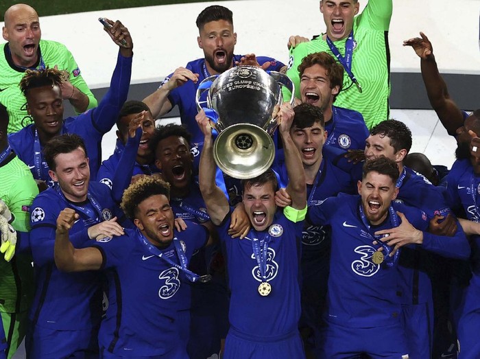 Chelsea supporters celebrate in west London, England after their team won the Champions League final soccer match between Manchester City and Chelsea which is being played at the Dragao stadium in Porto, Portugal, Saturday, May 29, 2021. Chelsea won the match 1-0. (AP Photo/Matt Dunham)