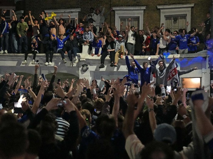 Chelsea supporters celebrate in west London, England after their team won the Champions League final soccer match between Manchester City and Chelsea which is being played at the Dragao stadium in Porto, Portugal, Saturday, May 29, 2021. Chelsea won the match 1-0. (AP Photo/Matt Dunham)