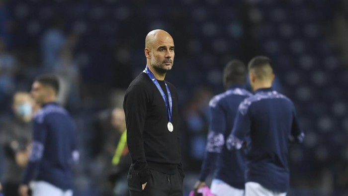 Manchester Citys head coach Pep Guardiola reacts after the Champions League final soccer match between Manchester City and Chelsea at the Dragao Stadium in Porto, Portugal, Saturday, May 29, 2021. (David Ramos/Pool via AP)