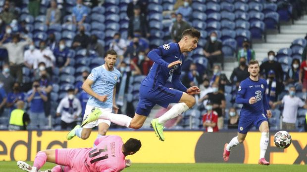 Chelsea's Kai Havertz jumps over Manchester City's goalkeeper Ederson and scores his side's first goal during the Champions League final soccer match between Manchester City and Chelsea at the Dragao Stadium in Porto, Portugal, Saturday, May 29, 2021. (Carl Recine/Pool via AP)