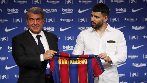 Soccer Football - FC Barcelona present new signing Sergio Aguero - Camp Nou, Barcelona, Spain - May 31, 2021 FC Barcelona's new signing Sergio Aguero holds his shirt with president Joan Laporta during the press conference REUTERS/Albert Gea