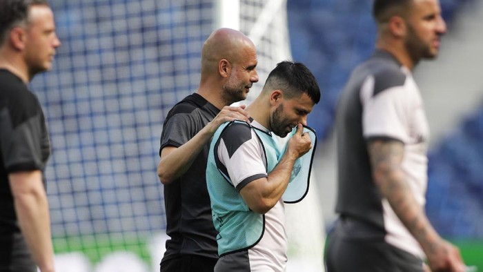 Manchester Citys head coach Pep Guardiola, left, talks to teammate Sergio Aguero during a training session ahead of the Champions League final match at the Dragao stadium in Porto, Portugal, Friday, May 28, 2021. Manchester City and Chelsea will play the Champions League final on Saturday. (AP Photo/Manu Fernandez)
