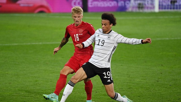 INNSBRUCK, AUSTRIA - JUNE 02: Leroy Sane of Germany battles for possession with Daniel Wass of Denmark during the international friendly match between Germany and Denmark at Tivoli Stadion Tirol on June 02, 2021 in Innsbruck, Austria.  (Photo by Federico Gambarini - Pool/Getty Images)