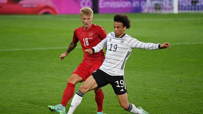 INNSBRUCK, AUSTRIA - JUNE 02: Leroy Sane of Germany battles for possession with Daniel Wass of Denmark during the international friendly match between Germany and Denmark at Tivoli Stadion Tirol on June 02, 2021 in Innsbruck, Austria. (Photo by Federico Gambarini - Pool/Getty Images)