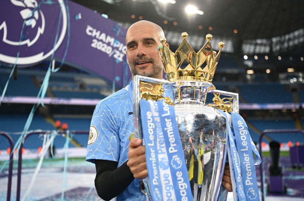 MANCHESTER, ENGLAND - MAY 23: Pep Guardiola, Manager of Manchester City celebrates with the Premier League Trophy as Manchester City are presented with the Trophy as they win the league following the Premier League match between Manchester City and Everton at Etihad Stadium on May 23, 2021 in Manchester, England. A limited number of fans will be allowed into Premier League stadiums as Coronavirus restrictions begin to ease in the UK. (Photo by Michael Regan/Getty Images)