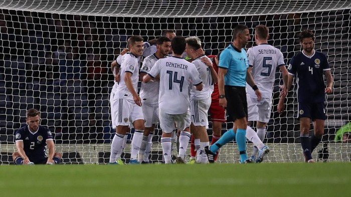 GLASGOW, SCOTLAND - SEPTEMBER 06: Stephen ODonnell of Scotland looks on as Yuri Zhirkov of Russia celebrates scoring his teams second goal during the UEFA Euro 2020 qualifier between Scotland and Russia at Hampden Park on September 06, 2019 in Glasgow, Scotland. (Photo by Ian MacNicol/Getty Images)