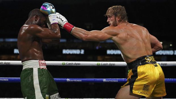 Jun 6, 2021; Miami, Florida, USA; Floyd Mayweather Jr. (Green Trunks) fights Logan Paul (Yellow Trunks) during an exhibition boxing match at Hard Rock Stadium. Mandatory Credit: Jasen Vinlove-USA TODAY Sports