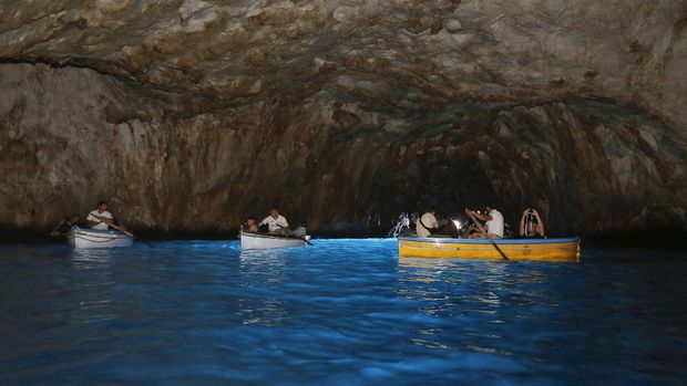 Island of Capri , Italy - may 23, 2016 - tourists on a boat tour visit interior of the grotto azzurra ( blue cave ) on coast of Island of Capri, Italy. iStockphoto/Leila Melhado