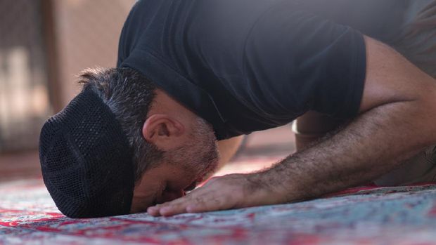 Muslim mature men prayer in mosque