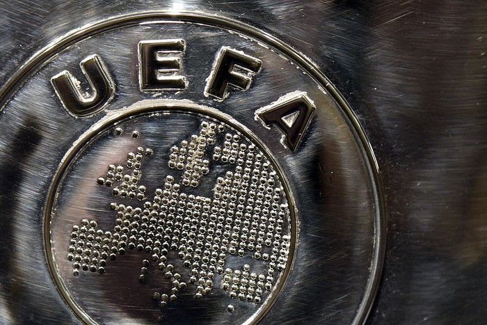 NYON, SWITZERLAND - JULY 18:  The UEFA logo is seen on the UEFA Champions League trophy as it is prepared for the UEFA 2014/15 Champions League third qualifying rounds draw at the UEFA headquarters, The House of European Football, on July 18, 2014 in Nyon, Switzerland.  (Photo by Harold Cunningham/Getty Images for UEFA)