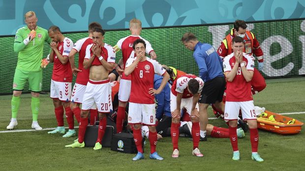 Denmark's players react as their teammate Christian Eriksen lays injured on the ground during the Euro 2020 soccer championship group B match between Denmark and Finland at Parken stadium in Copenhagen, Denmark, Saturday, June 12, 2021. (Wolfgang Rattay/Pool via AP)