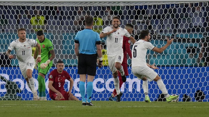 Italys Domenico Berardi celebrates after Turkeys Merih Demiral scored an own goal during the Euro 2020, soccer championship group A match between Italy and Turkey, at the Rome Olympic stadium, Friday, June 11, 2021. (AP Photo/Alessandra Tarantino, Pool)