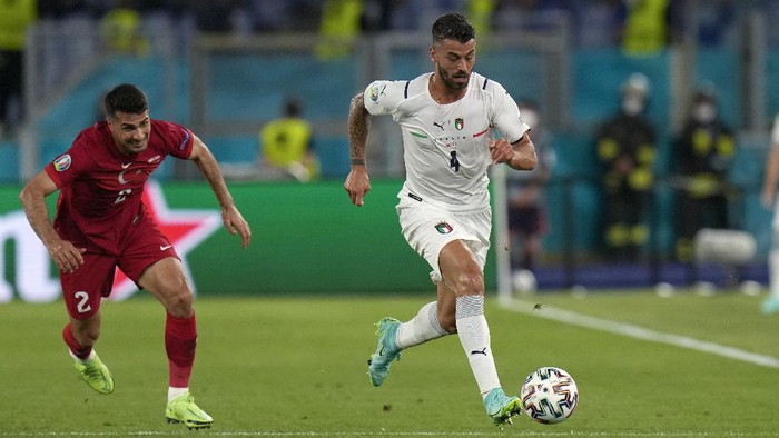 Italys Leonardo Spinazzola runs with the ball past Turkeys Zeki Celik during the Euro 2020, soccer championship group A match between Italy and Turkey, at the Rome Olympic stadium, Friday, June 11, 2021. (AP Photo/Alessandra Tarantino, Pool)