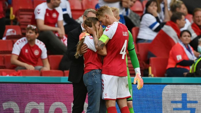 COPENHAGEN, DENMARK - JUNE 12: Sabrina Kvist Jensen, Girlfriend of Christian Eriksen (Not pictured) of Denmark looks dejected as she is consoled by Simon Kjaer of Denmark whilst Christian Eriksen receives medical treatment during the UEFA Euro 2020 Championship Group B match between Denmark and Finland on June 12, 2021 in Copenhagen, Denmark. (Photo by Stuart Franklin/Getty Images)