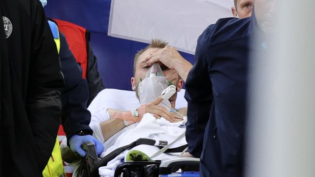 Paramedics using a stretcher to take out of the pitch Denmark's Christian Eriksen after he collapsed during the Euro 2020 soccer championship group B match between Denmark and Finland at Parken stadium in Copenhagen, Denmark, Saturday, June 12, 2021. (Friedemann Vogel/Pool via AP)
