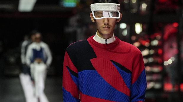 A model wears a creation as part of the Ferrari women's and men's Spring Summer 2022 collection, in Maranello, Italy, Sunday, June 13, 2021. (AP Photo/Antonio Calanni)