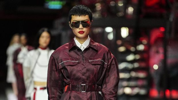 A model wears a creation as part of the Ferrari women's and men's Spring Summer 2022 collection, in Maranello, Italy, Sunday, June 13, 2021. (AP Photo/Antonio Calanni)