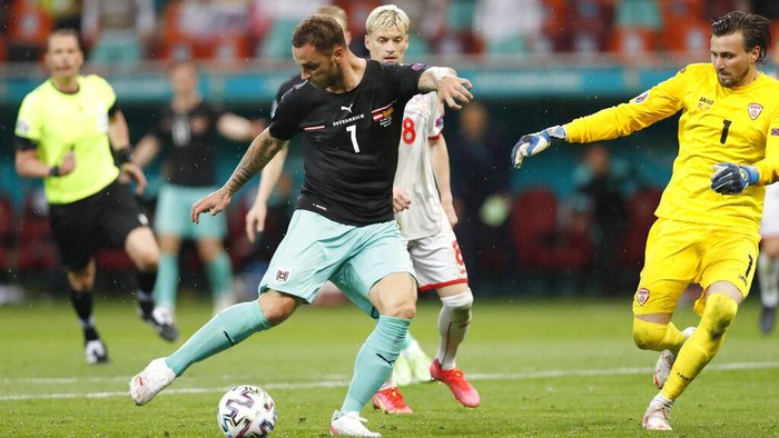 Marko Arnautovic Austria's Marko Arnautovic, left, scores his side's third goal during the Euro 2020 soccer championship group C match between Austria and Northern Macedonia at the National Arena stadium in Bucharest, Romania, Sunday, June 13, 2021. (Robert Ghement/PoolΒ via AP)