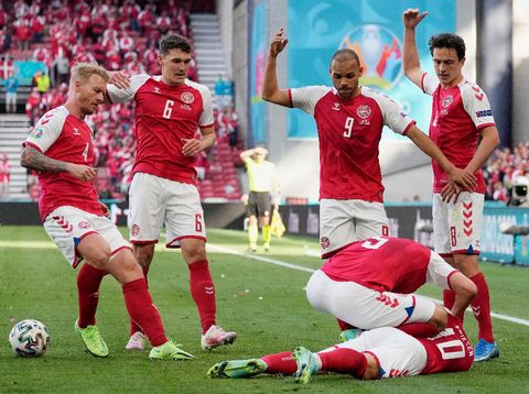 COPENHAGEN, DENMARK - JUNE 12: Christian Eriksen of Denmark goes down injured as team mates (L - R) Simon Kjaer, Andreas Christensen, Martin Braithwaite and Thomas Delaney call for assistance during the UEFA Euro 2020 Championship Group B match between Denmark and Finland on June 12, 2021 in Copenhagen, Denmark. (Photo by Martin Meissner - Pool/Getty Images)