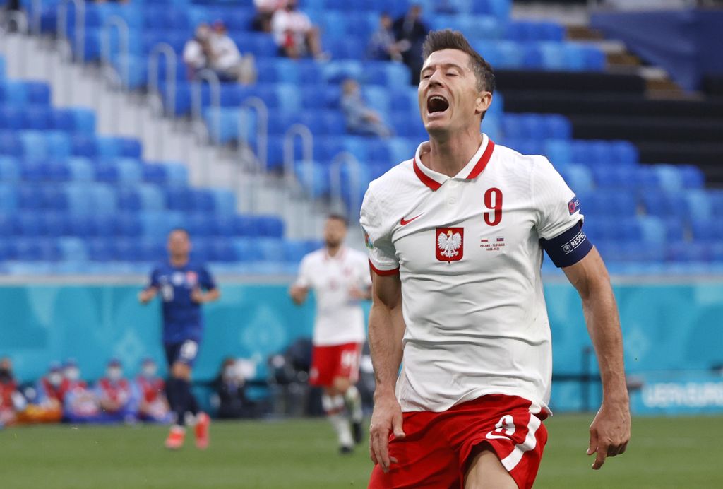 Poland's Robert Lewandowski reacts after missing a chance to score during the Euro 2020 soccer championship group E match between Poland v Slovakia at the Saint Petersburg stadium in St. Petersburg, Russia, Monday, June 14, 2021. (Evgenya Novozhenina/Pool via AP)