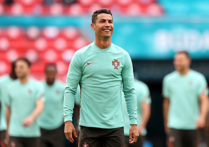Ronaldo BUDAPEST, HUNGARY - JUNE 14: Cristiano Ronaldo smiles during the Portugal Training Session ahead of the Euro 2020 Group F match between Hungary and Portugal at Puskas Arena on June 14, 2021 in Budapest, Hungary. (Photo by Alex Pantling/Getty Images)