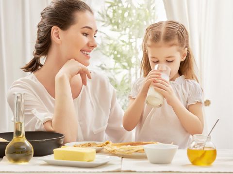 girl drinking milk at the kitchen