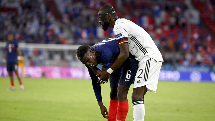 Germany's Antonio Ruediger, right, stands beside France's Paul Pogba during the Euro 2020 soccer championship group F match between France and Germany at the Allianz Arena stadium in Munich, Tuesday, June 15, 2021. (Matthias Hangst/Pool via AP)