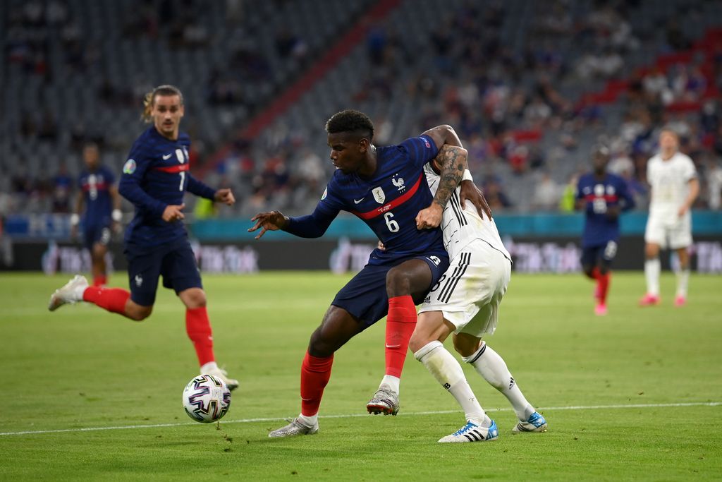MUNICH, GERMANY - JUNE 15: Paul Pogba of France is challenged by Toni Kroos of Germany during the UEFA Euro 2020 Championship Group F match between France and Germany at Football Arena Munich on June 15, 2021 in Munich, Germany. (Photo by Matthias Hangst/Getty Images)