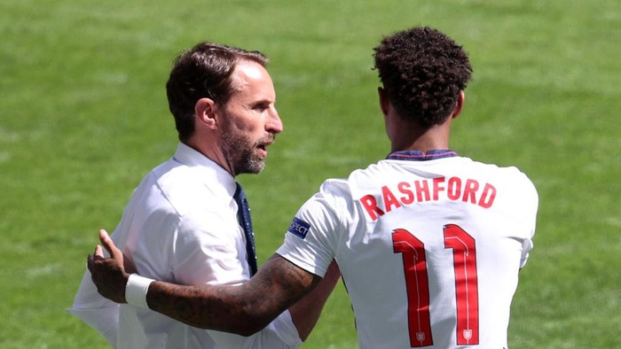 LONDON, ENGLAND - JUNE 13: Gareth Southgate, Head Coach of England speaks with Marcus Rashford of England before he enters the pitch as a substitute during the UEFA Euro 2020 Championship Group D match between England and Croatia at Wembley Stadium on June 13, 2021 in London, England. (Photo by Catherine Ivill/Getty Images)