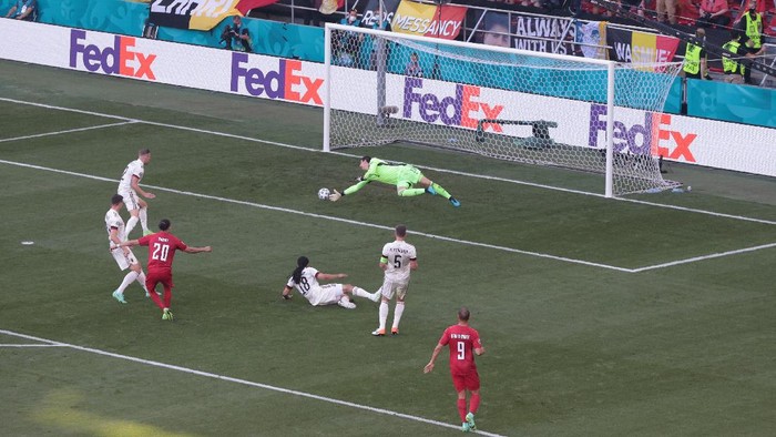 COPENHAGEN, DENMARK - JUNE 17: Yussuf Poulsen of Denmark scores their sides first goal past Thibaut Courtois of Belgium during the UEFA Euro 2020 Championship Group B match between Denmark and Belgium at Parken Stadium on June 17, 2021 in Copenhagen, Denmark. (Photo by Hanna McKay - Pool/Getty Images)