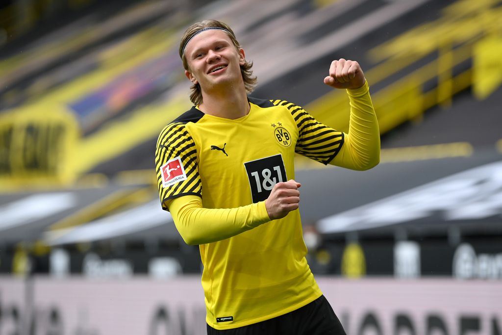 DORTMUND, GERMANY - MAY 22: Erling Haaland of Borussia Dortmund celebrates after scoring their team's first goal  during the Bundesliga match between Borussia Dortmund and Bayer 04 Leverkusen at Signal Iduna Park on May 22, 2021 in Dortmund, Germany. Sporting stadiums around Germany remain under strict restrictions due to the Coronavirus Pandemic as Government social distancing laws prohibit fans inside venues resulting in games being played behind closed doors. (Photo by Matthias Hangst/Getty Images)