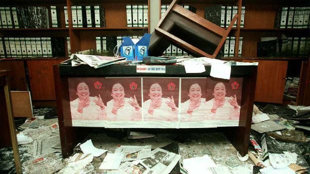 Posters featuring ousted Indonesian Democracy Party (PDI) leader Megawati Sukarnoputri still adorn a desk in the sacked PDI headquarters 31 July.  The sacking of the headquarters provoked mass riots that led to 22 buildings being burned down in central Jakarta, prompting a strong military response.AFP PHOTO (Photo by JOHN MACDOUGALL / AFP)