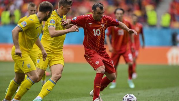 North Macedonia's Goran Pandev, right, duels for the ball with Ukraine's Illya Zabarnyi during the Euro 2020 soccer championship group C match between Ukraine and North Macedonia at the National Arena stadium in Bucharest, Romania, Thursday, June 17, 2021. (Justin Setterfield, Pool via AP)
