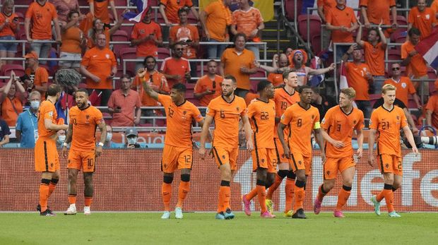 Memphis Depay, second from left, of the Netherlands celebrates with his teammates after scoring his side's opening goal during the Euro 2020 soccer championship group C match between the The Netherlands and Austria at Johan Cruijff ArenA in Amsterdam, Netherlands, Thursday, June 17, 2021. (AP Photo/Peter Dejong, Pool)