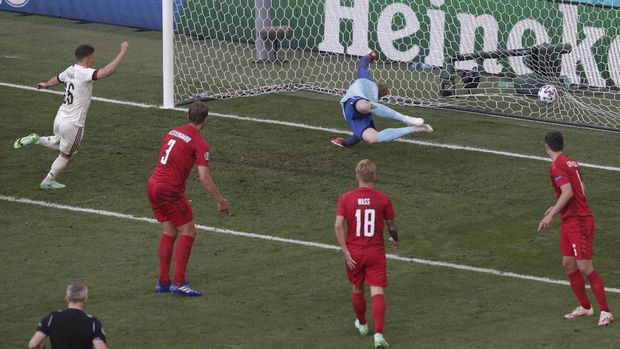 Belgium's Thorgan Hazard, left, scores his side's opening goal during the Euro 2020 soccer championship group B match between Denmark and Belgium at the Parken stadium in Copenhagen, Denmark, Thursday, June 17, 2021. (Hannah McKay/Pool via AP)