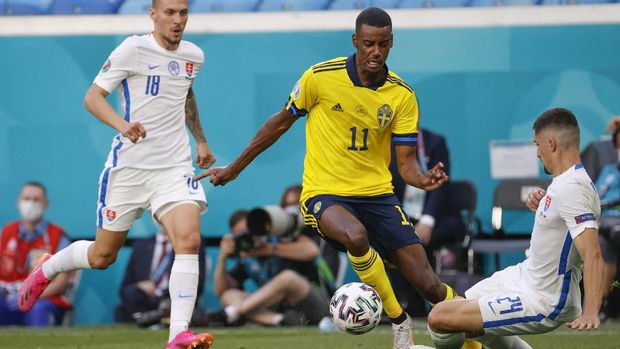 Sweden's Alexander Isak is challenged by Slovakia's Martin Koscelnik, right, during the Euro 2020 soccer championship group E match between Sweden and Slovakia, at the Saint Petersburg stadium, in Saint Petersburg, Russia, Friday, June 18, 2021. (Anatoly Maltsev, Pool via AP)