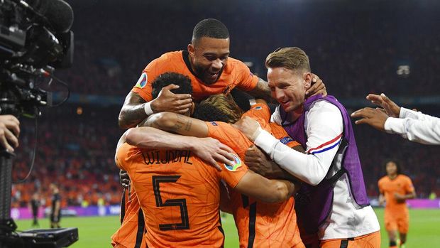 Denzel Dumfries, covered by his teammates, of the Netherlands celebrates after scoring his side's second goal during the Euro 2020 soccer championship group C match between the The Netherlands and Austria at Johan Cruijff ArenA in Amsterdam, Netherlands, Thursday, June 17, 2021. (John Thys, Pool via AP)