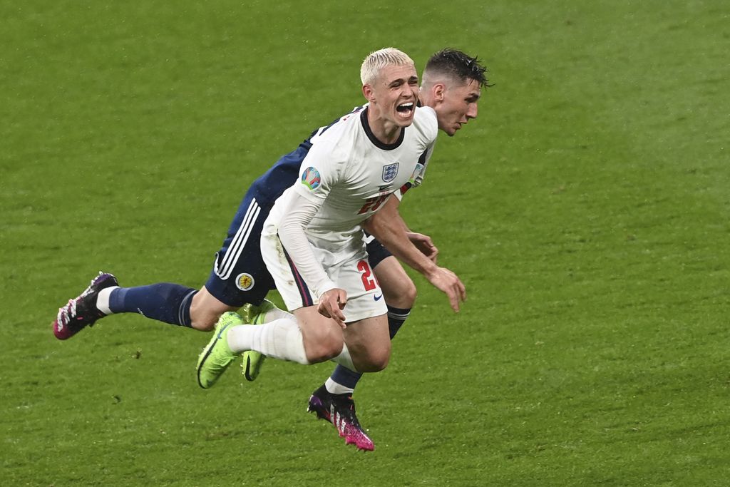 Scotland's Billy Gilmour, left, and England's Phil Foden vie for the ball during the Euro 2020 soccer championship group D match between England and Scotland at Wembley stadium in London, Friday, June 18, 2021. (Carl Recine/Pool Photo via AP)