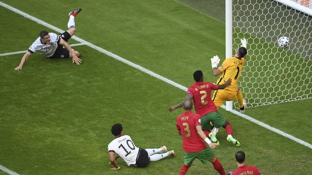 Germany's Robin Gosens, left, scores a goal that was later disallowed for offside during the Euro 2020 soccer championship group F match between Portugal and Germany at the football arena stadium in Munich, Saturday, June 19, 2021. (Matthias Hangst/Pool Photo via AP)