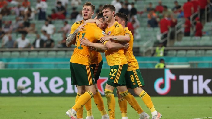 BAKU, AZERBAIJAN - JUNE 16: Chris Mepham of Wales celebrates with team mates after their sides second goal scored by Connor Roberts (Not pictured) during the UEFA Euro 2020 Championship Group A match between Turkey and Wales at Baku Olimpiya Stadionu on June 16, 2021 in Baku, Azerbaijan. (Photo by Tolga Bozoglu - Pool/Getty Images)