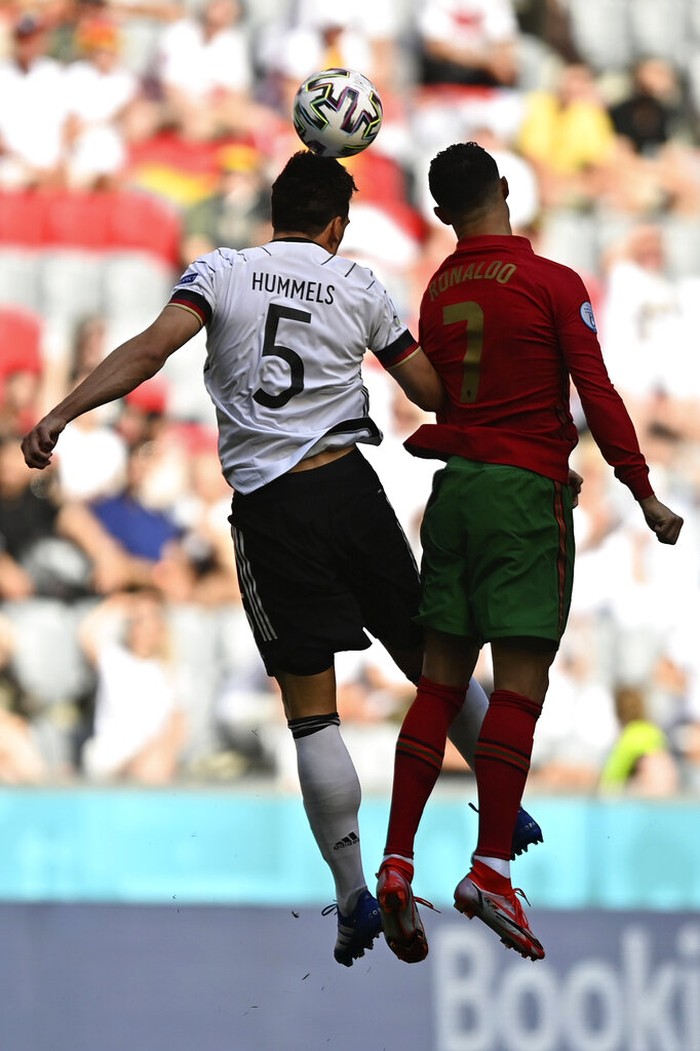 Cristiano Ronaldo, Mats Hummels Germany's Mats Hummels, left, jumps for the ball with Portugal's Cristiano Ronaldo during the Euro 2020 soccer championship group F match between Portugal and Germany at the Football Arena stadium in Munich, Germany, Saturday, June 19, 2021. (Philipp Guelland/Pool via AP)