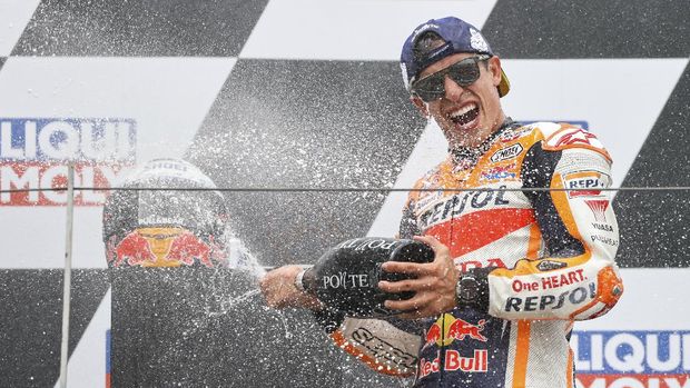 Spain's Marc Marquez of the Repsol Honda Team cheers after the medal ceremony at the Moto GP race at the Sachsenring circuit in Hohenstein-Ernstthal, Germany, Sunday, June 20, 2021. (Jan Woitas/dpa via AP)