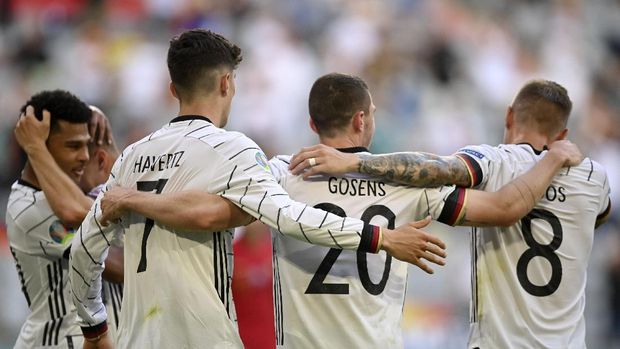 Germany's Robin Gosens celebrates with Kai Havertz and Toni Kroos, right, after scoring his side's fourth goal during the Euro 2020 soccer championship group F match between Portugal and Germany at the Football Arena stadium in Munich, Germany, Saturday, June 19, 2021. (Philipp Guelland/Pool via AP)