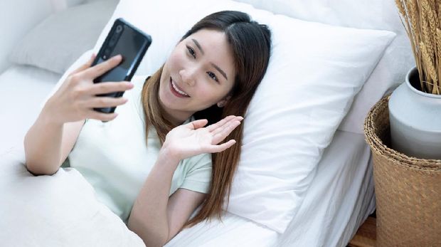 Asian woman using smartphone for video call, looking at screen of smartphone, Modern technologies and communication.